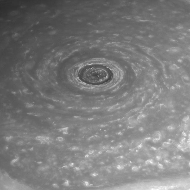 Like a giant eye for the giant planet, Saturn great vortex at its north pole appears to stare back at Cassini as NASA Cassini spacecraft stares at it. Measurements have sized the "eye" at a staggering 1,240 miles (2,000 kilometers) across with cloud speeds as fast as 330 miles per hour (150 meters per second). For color views of the eye and the surrounding region, see PIA14946 and PIA14944. The image was taken with the Cassini spacecraft narrow-angle camera on April 2, 2014 using a combination of spectral filters which preferentially admit wavelengths of near-infrared light centered at 748 nanometers. The view was obtained at a distance of approximately 1.4 million miles (2.2 million kilometers) from Saturn and at a Sun-Saturn-spacecraft, or phase, angle of 43 degrees. Image scale is 8 miles (13 kilometers) per pixel. http://photojournal.jpl.nasa.gov/catalog/PIA18273