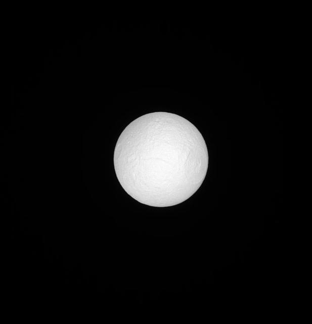 Seen by NASA Cassini spacecraft, Tethys, like many moons in the solar system, keeps one face pointed towards the planet around which it orbits. Tethys anti-Saturn face is seen here, fully illuminated, basking in sunlight. The Odysseus crater is 280 miles (450 kilometers) across while Tethys is 660 miles (1,062 kilometers) across. See PIA07693 for a closer view and more information on the Odysseus crater. This view looks toward the anti-Saturn side of Tethys. North on Tethys is up and rotated 33 degrees to the right. The image was taken in visible light with the Cassini spacecraft narrow-angle camera on June 15, 2013. The view was acquired at a distance of approximately 503,000 miles (809,000 kilometers) from Tethys. Image scale is 3 miles (5 kilometers) per pixel. http://photojournal.jpl.nasa.gov/catalog/PIA18275