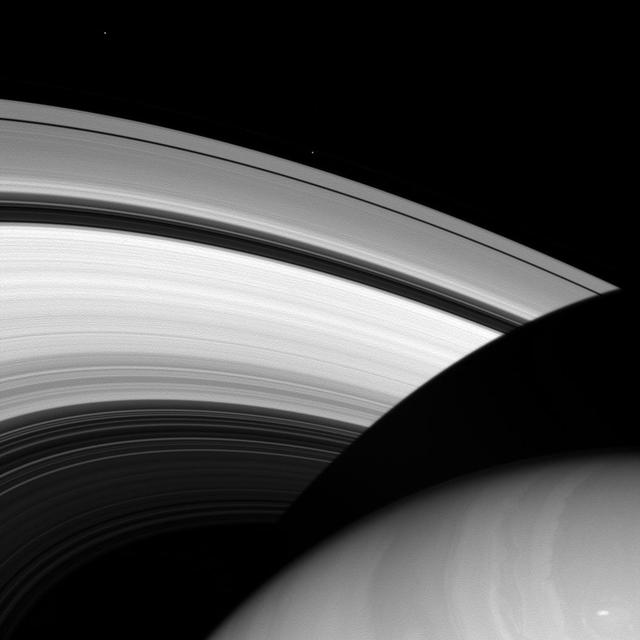 Befitting moons named for brothers, the moons Prometheus and Epimetheus share a lot in common. Both are small, icy moons that orbit near the main rings of Saturn. But, like most brothers, they also assert their differences: while Epimetheus is relatively round for a small moon, Prometheus is elongated in shape, similar to a lemon. Prometheus (53 miles, or 86 kilometers across) orbits just outside the A ring - seen here upper-middle of the image - while Epimetheus (70 miles, 113 kilometers across) orbits farther out - seen in the upper-left, doing an orbital two-step with its partner, Janus. This view looks toward the sunlit side of the rings from about 28 degrees above the ringplane. The image was taken in visible light with the Cassini spacecraft wide-angle camera on July 9, 2013. The view was obtained at a distance of approximately 557,000 miles (897,000 kilometers) from Saturn and at a Sun-Saturn-spacecraft, or phase, angle of 11 degrees. Image scale is 33 miles (54 kilometers) per pixel. Prometheus and Epimetheus have been brightened by a factor of 2 relative to the rest of the image to enhance their visibility. http://photojournal.jpl.nasa.gov/catalog/PIA18286