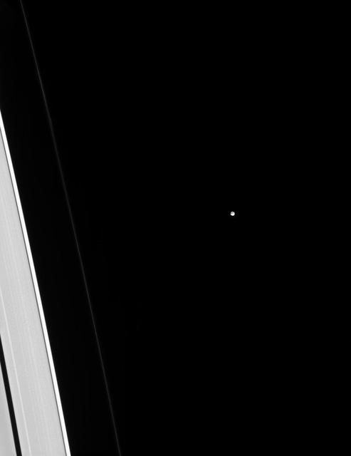 Tiny Epimetheus is dwarfed by adjacent slivers of the A and F rings. But is it really? Looks can be deceiving! There is approximately 10 to 20 times more mass in that tiny dot than in the piece of the A ring visible in this image! In total, Saturn's rings have about as much mass as a few times the mass of the moon Mimas. (This mass estimate comes from measuring the waves raised in the rings by moons like Epimetheus.) The rings look physically larger than any moon because the individual ring particles are very small, giving them a large surface area for a given mass. Epimetheus (70 miles or 113 kilometers across), on the other hand, has a small surface area per mass compared to the rings, making it look deceptively small. This view looks toward the sunlit side of the rings from about 19 degrees above the ringplane. The image was taken in visible light with the Cassini spacecraft narrow-angle camera on Dec. 5, 2014. The view was obtained at a distance of approximately 1.2 million miles (2 million kilometers) from Epimetheus and at a Sun-Epimetheus-spacecraft, or phase, angle of 40 degrees. Image scale is 7 miles (12 kilometers) per pixel. http://photojournal.jpl.nasa.gov/catalog/PIA18302