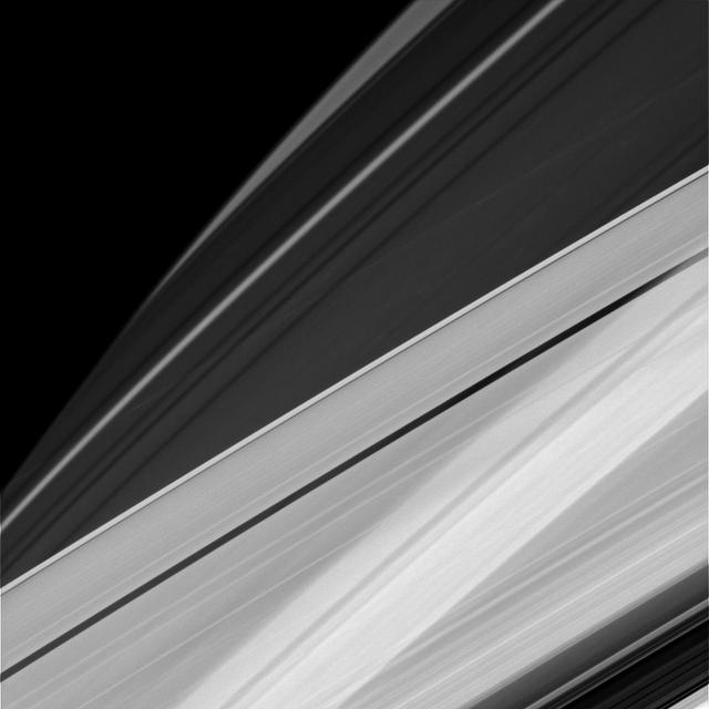 Sometimes at Saturn you can see things almost as if from every angle at once, the way a Cubist might imagine things. For example, in this image, we're seeing Saturn's A ring in the lower part of the image and the limb of Saturn in the upper. In addition, the rings cast their shadows onto the portion of the planet imaged here, creating alternating patterns of light and dark. This pattern is visible even through the A ring, which, unlike the core of the nearby B ring, is not completely opaque.  The ring shadows on Saturn often appear to cross the surface at confusing angles in close-ups like this one. The visual combination of Saturn's oblateness, the varying opacity of its rings and the shadows cast by those rings, sometimes creates elaborate and complicated patterns from Cassini's perspective.  This view looks toward the sunlit side of the rings from about 19 degrees above the ringplane. The image was taken in visible light with the Cassini spacecraft narrow-angle camera on Dec. 5, 2014.  The view was obtained at a distance of approximately 1.2 million miles (2 million kilometers) from Saturn. Image scale is 7 miles (11 kilometers) per pixel.  http://photojournal.jpl.nasa.gov/catalog/PIA18303