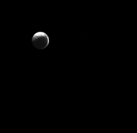 The moon Iapetus, like the "force" in Star Wars, has both a light side and a dark side.  Scientists think that Iapetus' (914 miles or 1471 kilometers across) dark/light asymmetry was actually created by material migrating away from the dark side. For a simulation of how scientists think the asymmetry formed, see Thermal Runaway Model .  Lit terrain seen here is on the Saturn-facing hemisphere of Iapetus. North on Iapetus is up and rotated 43 degrees to the right. The image was taken in green light with the Cassini spacecraft narrow-angle camera on Jan. 4, 2015.  The view was acquired at a distance of approximately 2.5 million miles (4 million kilometers) from Iapetus. Image scale is 15 miles (24 kilometers) per pixel.  http://photojournal.jpl.nasa.gov/catalog/pia18307