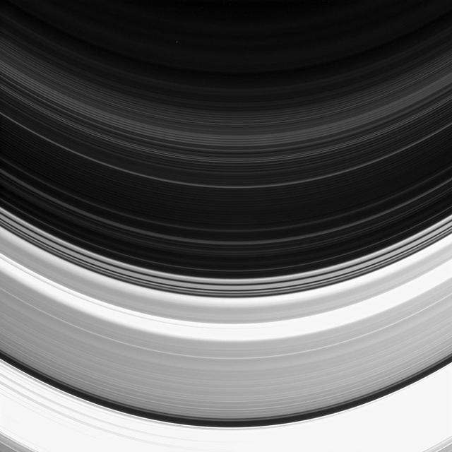 Not all of Saturn's rings are created equal: here the C and D rings appear side-by-side, but the C ring, which occupies the bottom half of this image, clearly outshines its neighbor. The D ring appears fainter than the C ring because it is comprised of less material. However, even rings as thin as the D ring can pose hazards to spacecraft. Given the high speeds at which Cassini travels, impacts with particles just fractions of a millimeter in size have the potential to damage key spacecraft components and instruments. Nonetheless, near the end of Cassini's mission, navigators plan to thread the spacecraft's orbit through the narrow region between the D ring and the top of Saturn's atmosphere. This view looks toward the unilluminated side of the rings from about 12 degrees below the ringplane. The image was taken in visible light with the Cassini spacecraft narrow-angle camera on Feb. 11, 2015. The view was acquired at a distance of approximately 372,000 miles (599,000 kilometers) from Saturn and at a Sun-Saturn-spacecraft, or phase, angle of 133 degrees. Image scale is 2.2 miles (3.6 kilometers) per pixel. http://photojournal.jpl.nasa.gov/catalog/pia18313