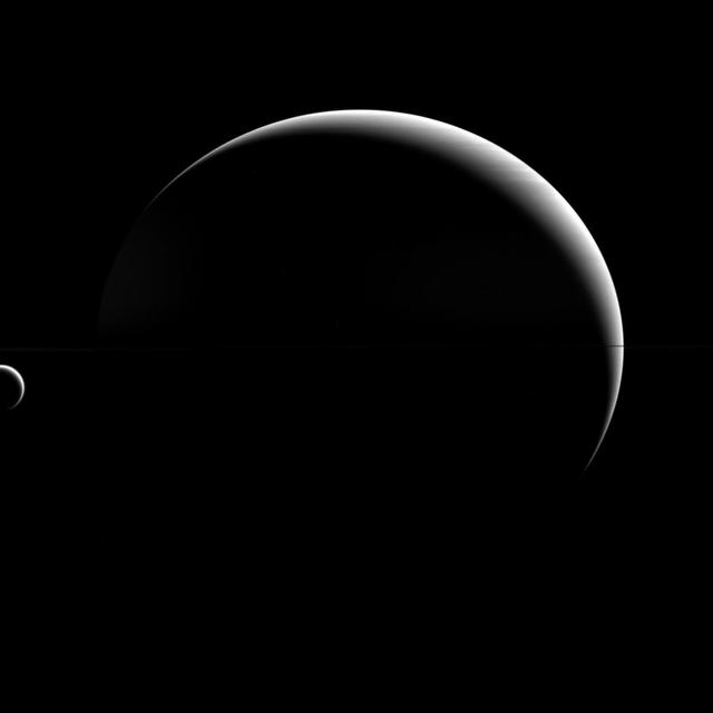 Titan may be a "large" moon -- its name even implies it! -- but it is still dwarfed by its parent planet, Saturn. As it turns out, this is perfectly normal.  Although Titan (3200 miles or 5150 kilometers across) is the second-largest moon in the solar system, Saturn is still much bigger, with a diameter almost 23 times larger than Titan's. This disparity between planet and moon is the norm in the solar system. Earth's diameter is "only" 3.7 times our moon's diameter, making our natural satellite something of an oddity. (Another exception to the rule: dwarf planet Pluto's diameter is just under two times that of its moon.) So the question isn't why is Titan so small (relatively speaking), but why is Earth's moon so big?  This view looks toward the anti-Saturn hemisphere of Titan. North on Titan is up. The image was taken with the Cassini spacecraft wide-angle camera on April 18, 2015 using a near-infrared spectral filter with a passband centered at 752 nanometers.  The view was acquired at a distance of approximately 930,000 miles (1.5 million kilometers) from Titan. Image scale is 56 miles (90 kilometers) per pixel.  http://photojournal.jpl.nasa.gov/catalog/PIA18326