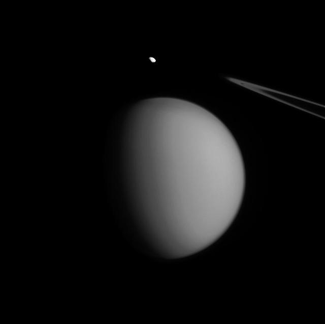 A coincidence of viewing angle makes Pandora appear to be hovering over Titan, almost like an accent mark. Little Pandora is much closer to Cassini than hazy Titan in this view. (Titan is nearly three times farther away.) Even so, Titan (3,200 miles or 5,150 kilometers across) dwarfs Pandora (50 miles or 81 kilometers across). This gives us some sense of the diversity in sizes, and shapes, of Saturn's many moons. North on Titan is up and rotated 19 degrees to the right. The image was taken in visible green light with the Cassini spacecraft narrow-angle camera on July 4, 2015. The view was acquired at a distance of approximately 1.2 million miles (1.9 million kilometers) from Titan. Image scale is 7 miles (12 kilometers) per pixel on Titan. Pandora is at a distance of 436,000 miles (698,000 kilometers) away from the spacecraft. The scale on Pandora is about 3 miles (4 kilometers) per pixel. http://photojournal.jpl.nasa.gov/catalog/PIA18338