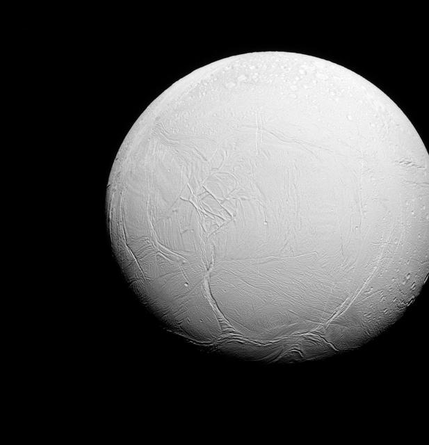 Enceladus is a world divided. To the north, the terrain is covered in impact craters, much like other icy moons. But to the south, the record of impact cratering is much more sparse, and instead the land is covered in fractures, ropy or hummocky terrain and long, linear features.  Lit terrain seen here is on the trailing side of Enceladus. North on Enceladus is up. The image was taken in visible green light with the Cassini spacecraft narrow-angle camera on July 27, 2015.  The view was obtained at a distance of approximately 70,000 miles (112,000 kilometers) from Enceladus and at a Sun-Enceladus-spacecraft, or phase, angle of 25 degrees. Image scale is 0.4 miles (0.7 kilometers) per pixel.   http://photojournal.jpl.nasa.gov/catalog/PIA18340