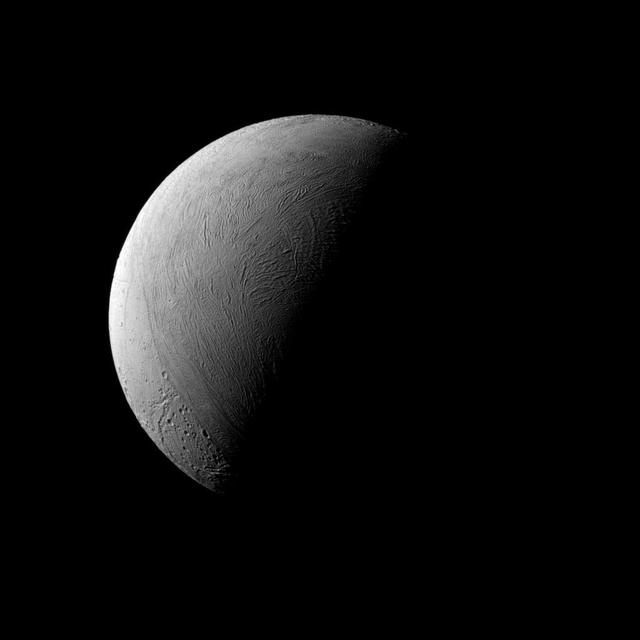 This half-lit view of Enceladus bears a passing resemblance to similar views of Earth's own natural satellite, but the similarities end there. Earth's rocky moon is covered in dark, volcanic basins and brighter, mountainous highlands -- both exceedingly ancient. The surface of icy Enceladus is uniformly bright, far brighter than Earth's moon. Large areas of Enceladus' surface are characterized by youthful (on geologic timescales), wrinkled terrains. Although the north pole of Enceladus (313 miles or 504 kilometers across) was dark when Cassini arrived at Saturn, the march of the seasons at Saturn have brought sunlight to the north and taken it from the south. This view looks toward the leading hemisphere of Enceladus. North on Encealdus is up. The image was taken in visible light with the Cassini spacecraft narrow-angle camera on Sept. 8, 2015. The view was acquired at a distance of approximately 80,000 miles (129,000 kilometers) from Enceladus. Image scale is 2,530 feet (772 meters) per pixel. http://photojournal.jpl.nasa.gov/catalog/PIA18351