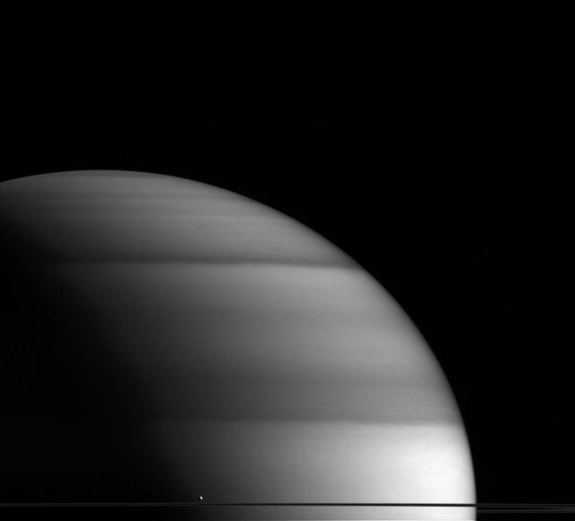 The water-world Enceladus appears here to sit atop Saturn rings like a drop of dew upon a leaf in this view from NASA Cassini spacecraft.