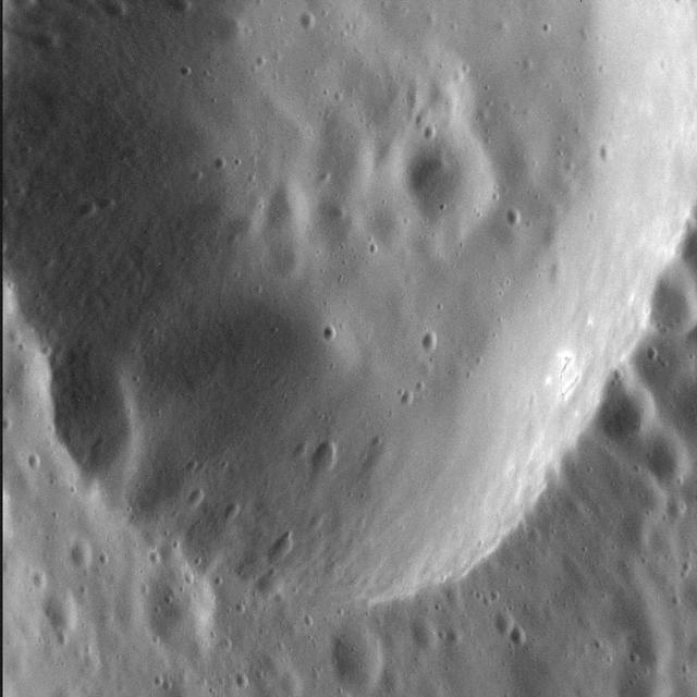 As MESSENGER passes progressively closer to Mercury, we see ever more resolved features in the images the spacecraft returns. Here, at a pixel scale of 9 meters, we see the eastern portion of an unnamed crater 13 km (8 mi.) in diameter. The wall of the crater is replete with smaller, superposed craters, some of which appear elongate possibly because they impacted on the larger crater's inclined wall. Interestingly, there are bright spots on the sunlight portion of this crater's wall -- which is where we might expect hollows to form. This image was acquired as a high-resolution targeted observation. Targeted observations are images of a small area on Mercury's surface at resolutions much higher than the 200-meter/pixel morphology base map. It is not possible to cover all of Mercury's surface at this high resolution, but typically several areas of high scientific interest are imaged in this mode each week. Date acquired: March 3, 2014 Image Mission Elapsed Time (MET): 36136338 Image ID: 5862963 Instrument: Narrow Angle Camera (NAC) of the Mercury Dual Imaging System (MDIS) Center Latitude: 56.3° Center Longitude: 301.6° E Resolution: 9 meters/pixel Scale: The field of view in this image is 11 km (7 mi.) across Incidence Angle: 59.3° Emission Angle: 43.0° Phase Angle: 102.3° North is to the right in this scene. http://photojournal.jpl.nasa.gov/catalog/PIA18372