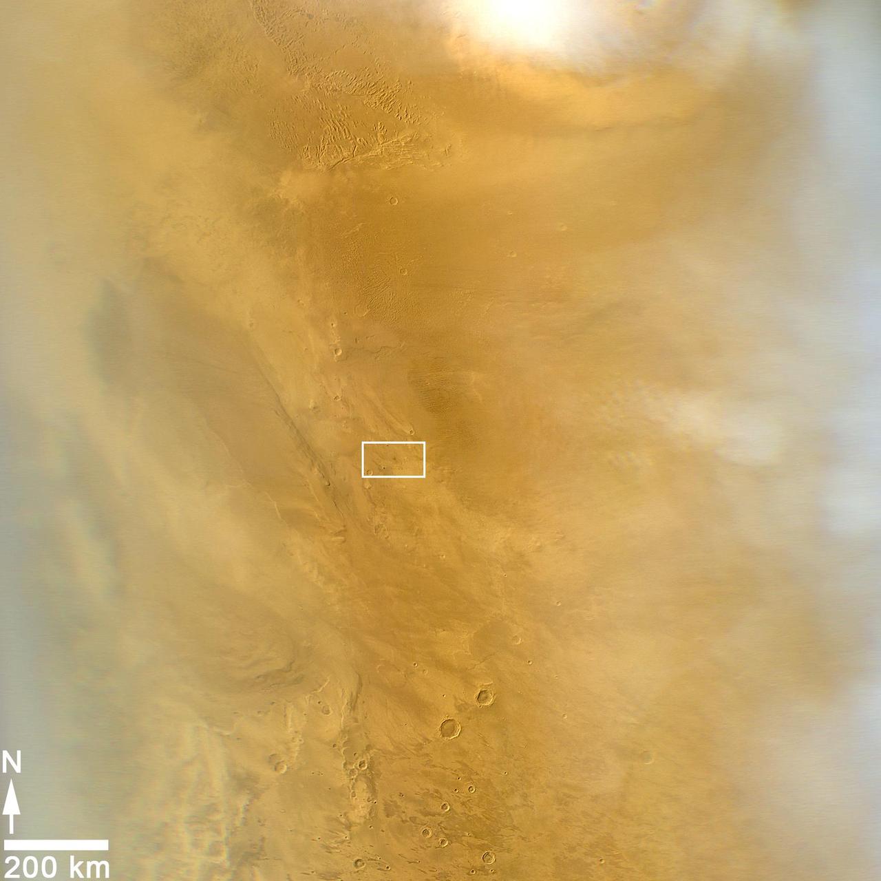 This March 20, 2014, image from the MARCI camera on NASA Mars Reconnaissance Orbiter has a dark spot at center of rectangle noticed while the image was being examined for a weather report.