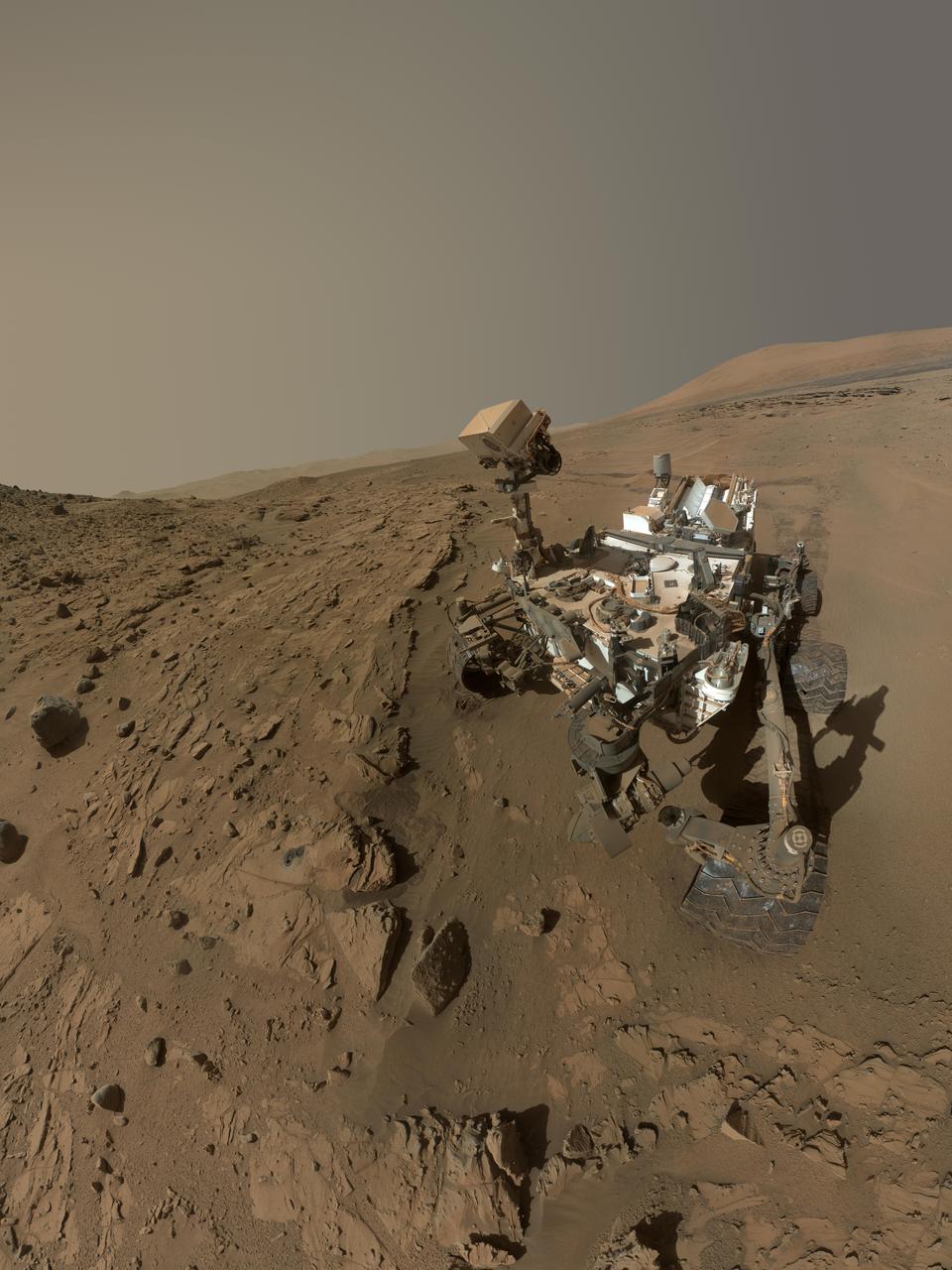 NASA Curiosity Mars rover used the MAHLI camera at the end of its arm in April and May 2014 to take dozens of component images combined into this self-portrait where the rover drilled into a sandstone target called Windjana.