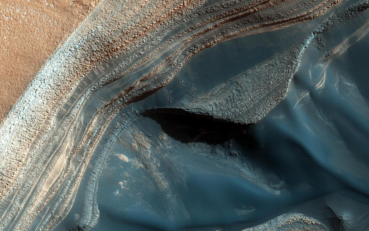 The North Polar layered deposits NPLD are a stack of layers of ice and dust at the North Pole of Mars. The layers are thought to have been deposited over millions of years. This image is from NASA Mars Reconnaissance Orbiter.
