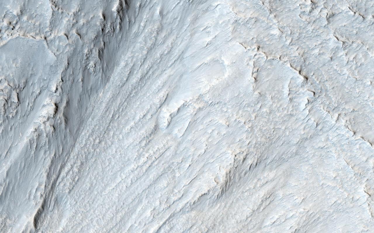 This image captured by NASA Mars Reconnaissance Orbiter appears to show some type of mass movement of material down the wall of a mesa in Deuteronilus Mensae.