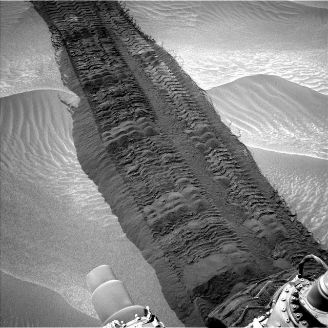 This image, taken on Aug. 4, 2014, from the Navigation Camera on NASA Curiosity Mars rover shows wheel tracks printed by the rover as it drove on the sandy floor of a lowland called Hidden Valley on the route toward Mount Sharp.