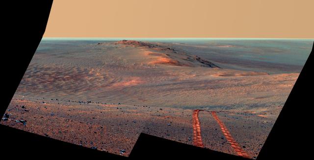 This false-color scene from the Pancam on NASA Mars Exploration Rover Opportunity looks back toward part of the west rim of Endeavour Crater that the rover drove along, heading southward, during the summer of 2014.