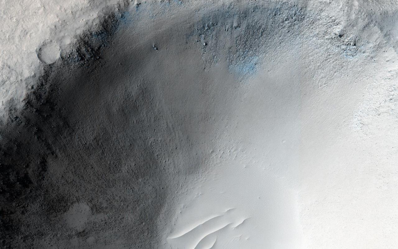 An impact crater in Isidis Planitia observed for a fifth time by NASA Mars Reconnaissance Orbiter.
