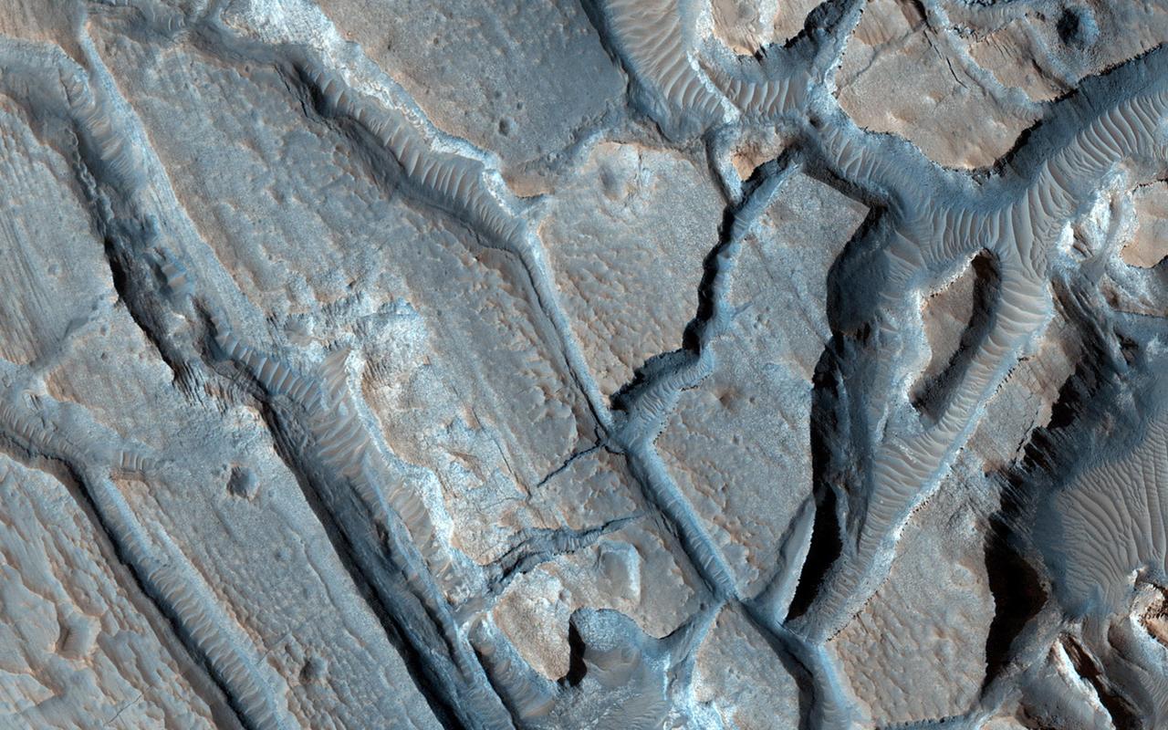 This image from NASA Mars Reconnaissance Orbiter shows some interesting fractured materials on the floor of an impact crater in Arabia Terra.