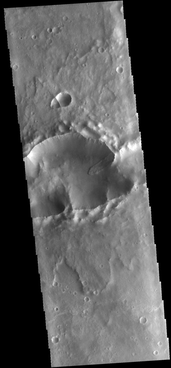 This image from NASA 2001 Mars Odyssey spacecraft shows a landslide deposit within a complex crater note the ejecta to the top and bottom of the image. There is a smaller complex crater on the ejecta to the north of the larger crater.