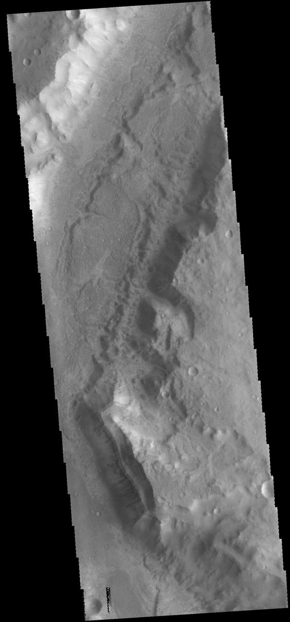 This image from NASA 2001 Mars Odyssey spacecraft shows a portion of Maadim Vallis, which is a large channel that enters Gusev Crater from the south.