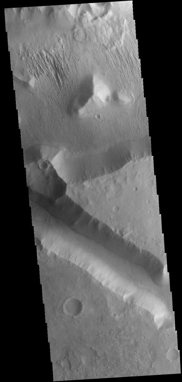 This image captured by NASA 2001 Mars Odyssey spacecraft shows a small portion of Aeolis Mensae, a complex region of hills, plateaus and graben.