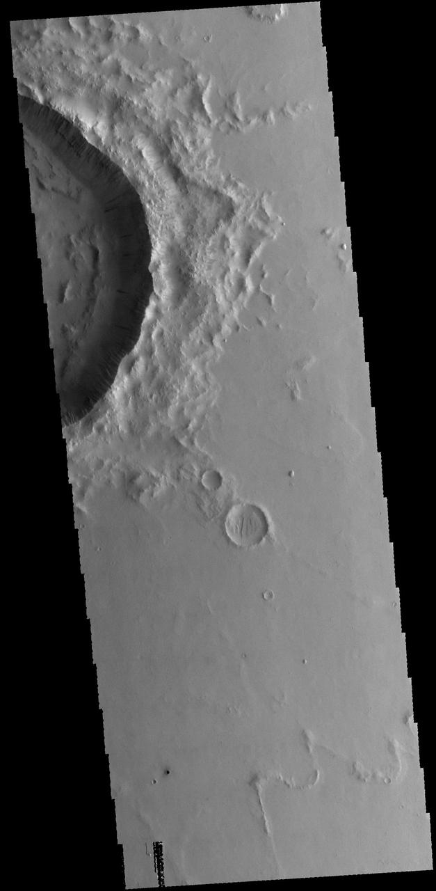 This image from NASA 2001 Mars Odyssey spacecraft shows dark slope streaks on the inner rim of an unnamed crater in Amazonis Planitia.