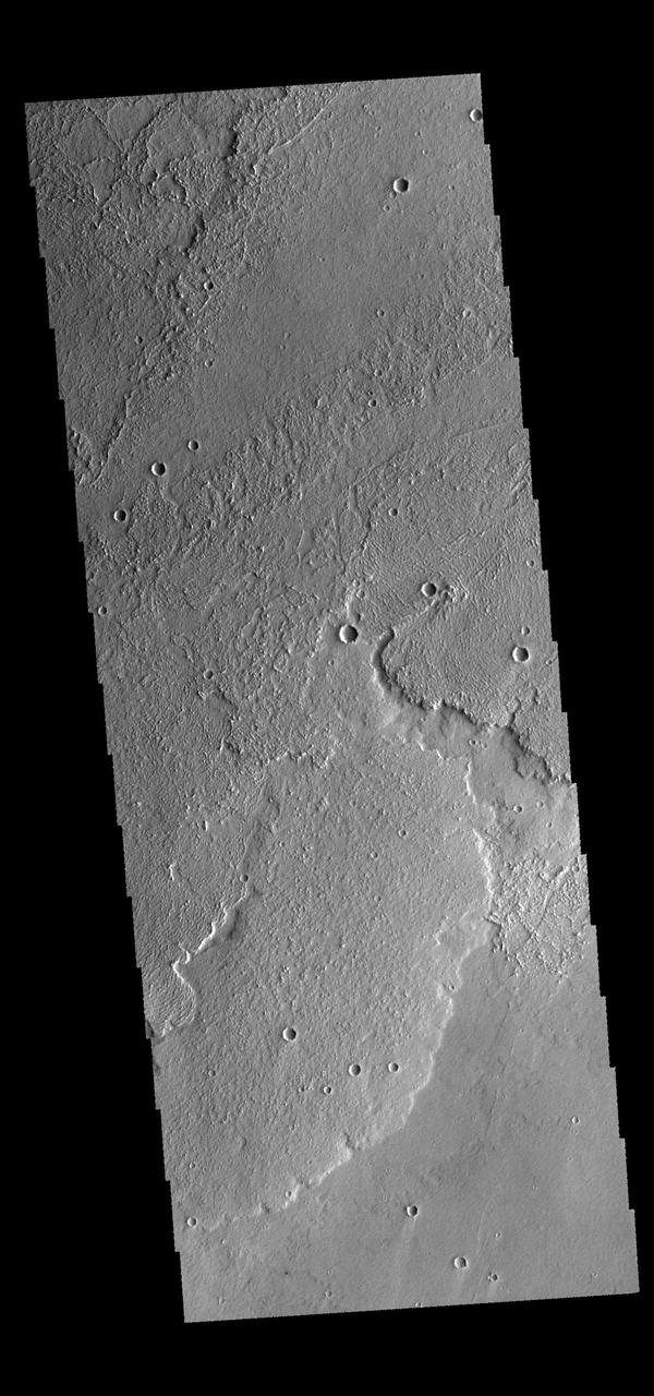 This image captured by NASA 2001 Mars Odyssey spacecraft shows a small portion of Daedalia Planum, a huge region of volcanic flows south of Arsia Mons.