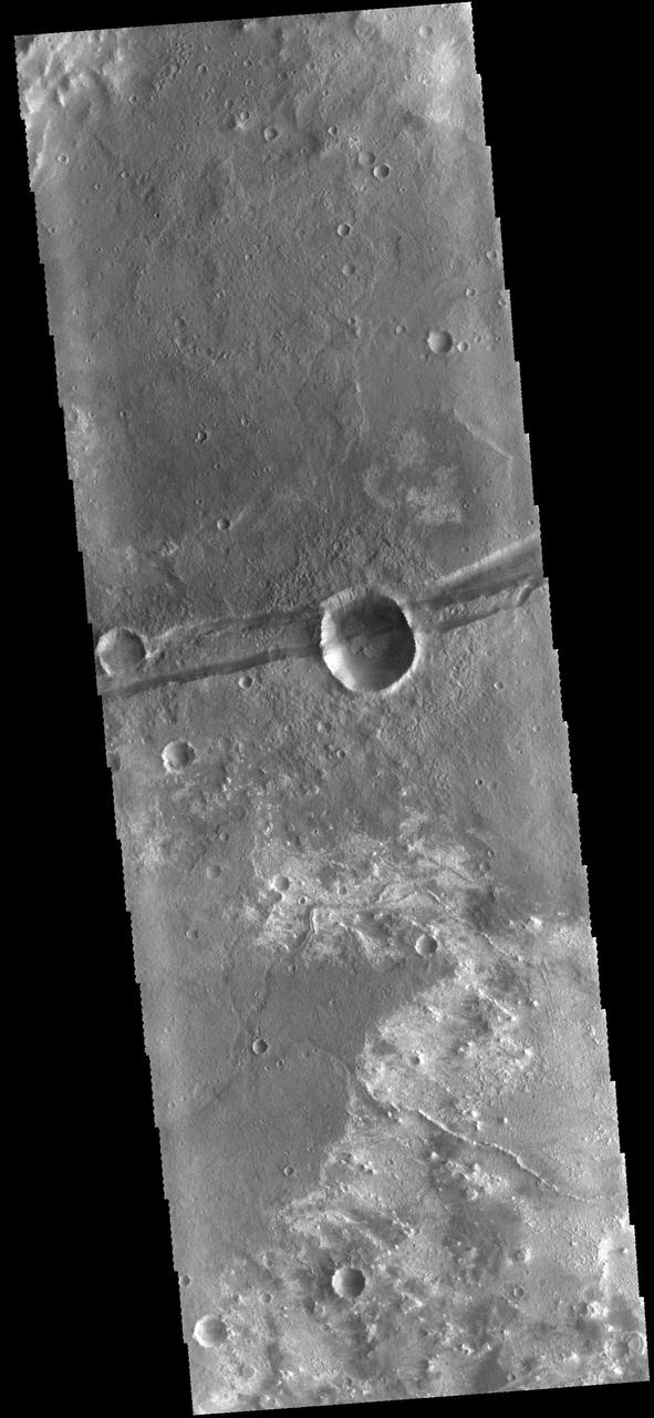 The linear depression in the center of this image captured by NASA Mars Odyssey spacecraft is a graben - a fault bounded block of material. The graben crosses the crater and ejecta in the middle of the image.