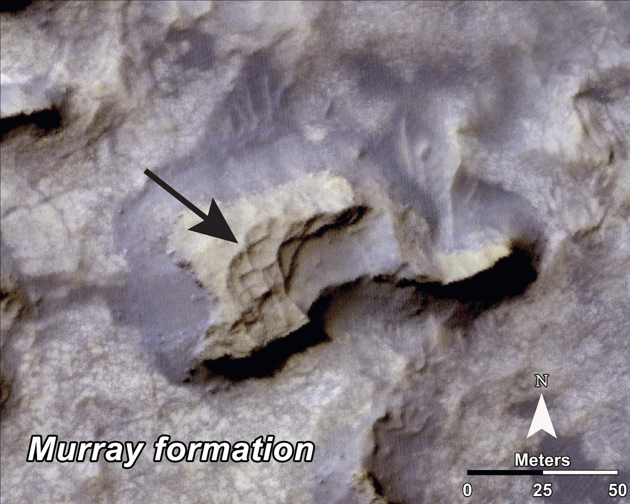 This image, taken by NASA Mars Reconnaissance Orbiter, shows a mesa within the Murray Buttes area on Mars showing a complex fracture pattern black arrow protruding from the eroding rock.