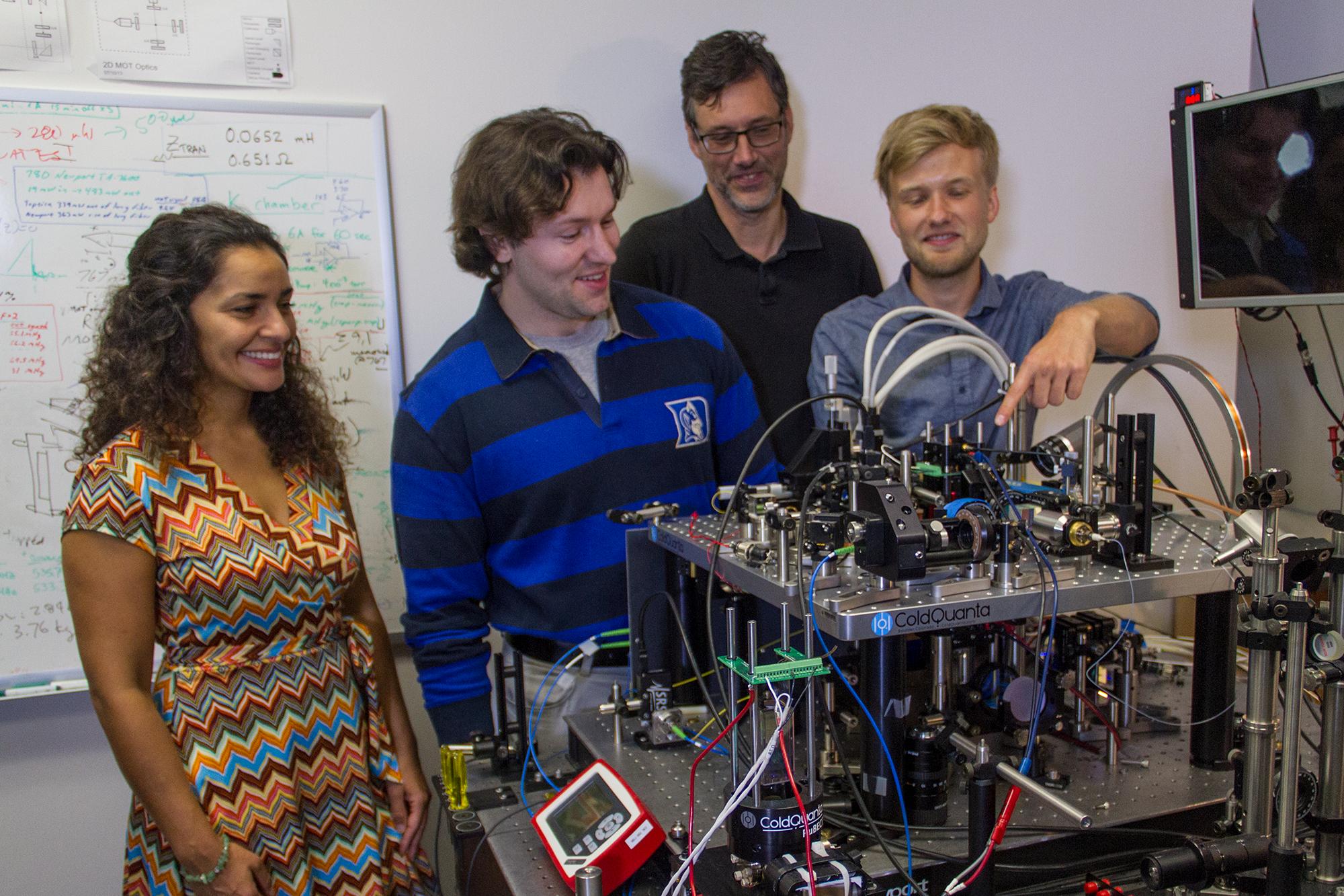 Members of the Cold Atom Laboratory team at NASA Jet Propulsion Laboratory are seen here with their ground-based testbed, which can reliably create a Bose-Einstein condensate.