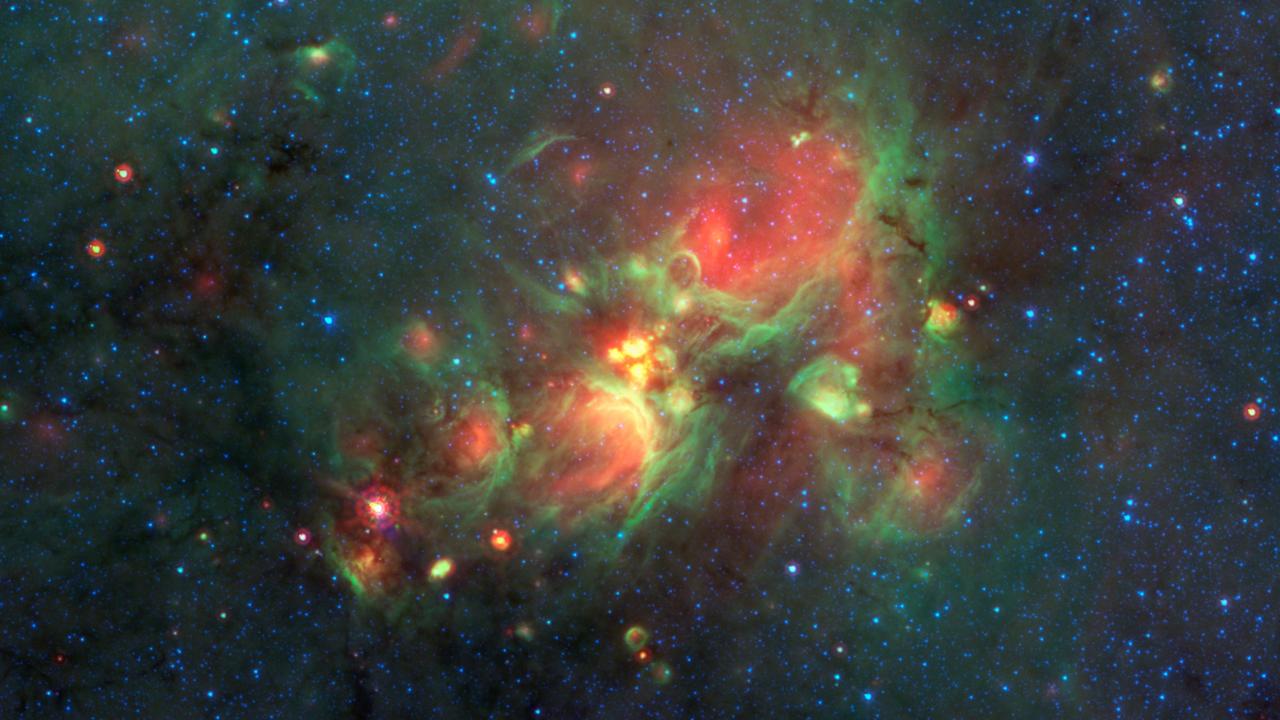 Yellow balls -- which are several hundred to thousands times the size of our solar system -- are pictured here in the center of this image taken by NASA Spitzer Space Telescope.