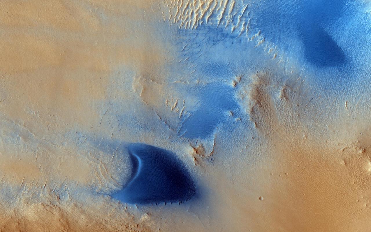 Arabia Terra is one of the more dusty regions on Mars, where ever-falling red dust covers the surface allowing only minor variations in color and tone as seen by NASA Mars Reconnaissance Orbiter.