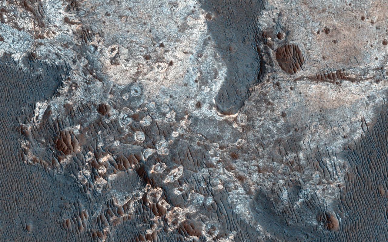 This image from NASA Mars Reconnaissance Orbiter shows exposures of deposits along the plateau just to the south of Coprates Chasma.