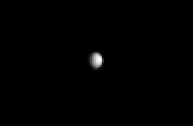 From about three times the distance from Earth to the moon, NASA's Dawn spacecraft spies its final destination -- the dwarf planet Ceres.  The resolution of this image does not yet exceed the best views of Ceres, which were obtained by the Hubble Space Telescope (see PIA10235). Nonetheless, Ceres' spherical shape is clearly revealed here. Sunlight illuminates the dwarf planet from the right, leaving a sliver of the surface in shadow at left.  A zoomed-in view is provided in Figure 1, along with the original unmagnified, uncropped view.  The image was taken on Dec. 1, 2014 with the Dawn spacecraft's framing camera, using a clear spectral filter. Dawn was about 740,000 miles (1.2 million kilometers) from Ceres at the time. Ceres is 590 miles (950 kilometers) across and was discovered in 1801.  http://photojournal.jpl.nasa.gov/catalog/PIA19049