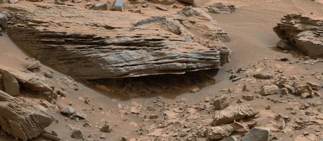 Cross-bedding seen in the layers of this Martian rock is evidence of movement of water recorded by the waves or ripples of loose sediment the water passed over, such as a current in a lake. This image is from NASA Curiosity Mars rover.
