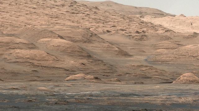 This view from the Mastcam on NASA Curiosity Mars rover shows dramatic buttes and layers on the lower flank of Mount Sharp. It was taken on Sept. 7, 2013, from near the waypoint called Darwin on the route toward an entry point to the mountain.