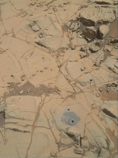 Gray cuttings from Curiosity drilling into a target called Mojave 2 are visible surrounding the sample-collection hole in this image from NASA Curiosity rover.