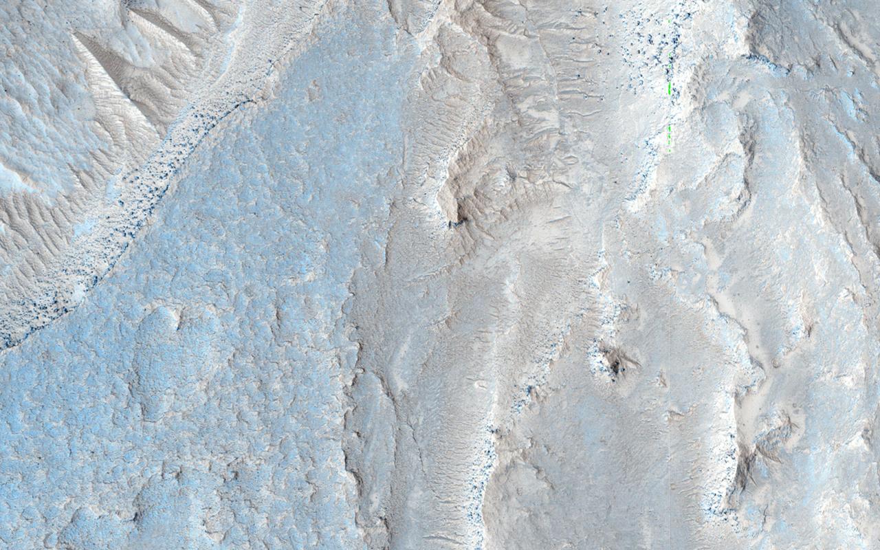 The image from NASA Mars Reconnaissance Orbiter is approximately 6 by 6 kilometers and is located east of Noctis Labyrinthus, in a portion the large canyon system Valles Marineris.