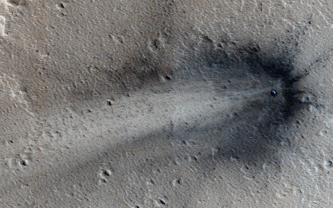 This image from NASA Mars Reconnaissance Orbiter shows a new impact crater in Elysium Planitia.