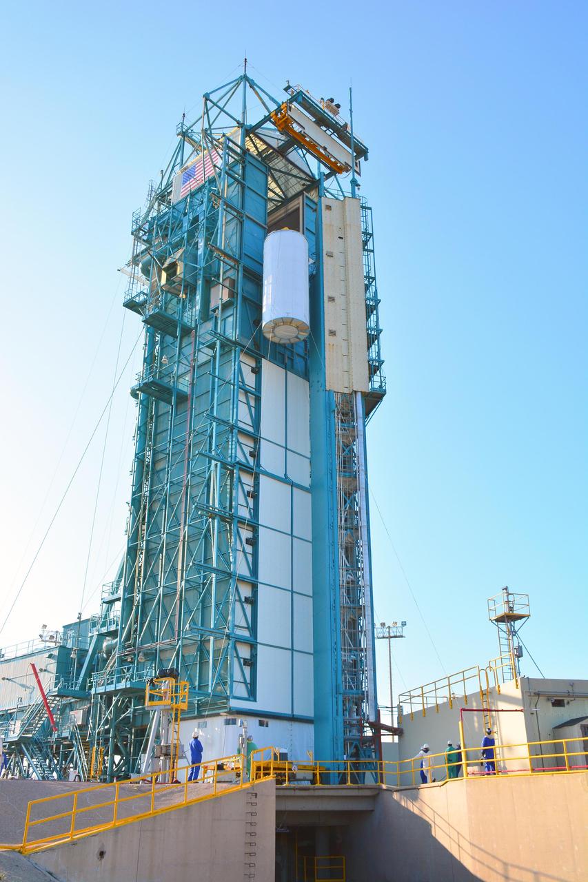 At Space Launch Complex 2 on Vandenberg Air Force Base in California, NASA Soil Moisture Active Passive SMAP mission satellite is lifted up the side of a mobile service tower for mating to its Delta II rocket.