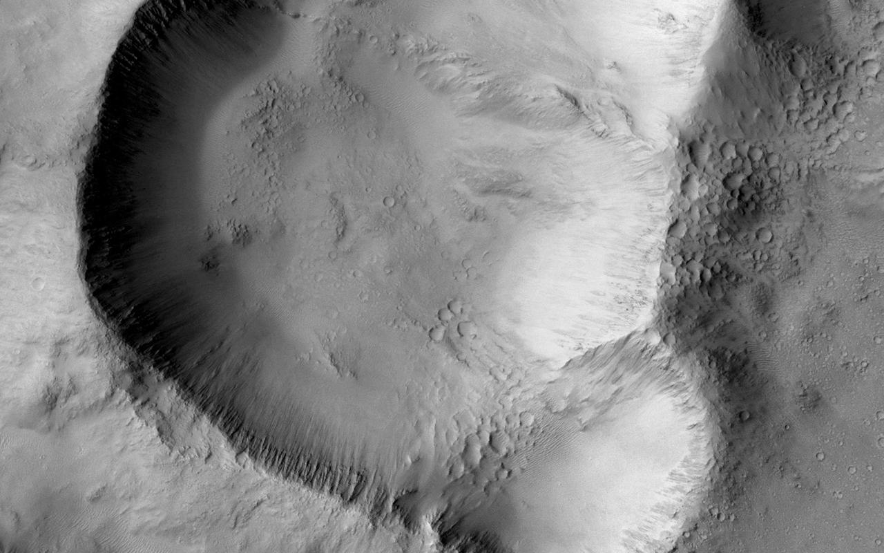This image from NASA Mars Mars Reconnaissance Orbiter shows a triple impact crater in Elysium Planitia near Tartarus Montes, which probably formed when a binary-or even triple-asteroid struck the surface.