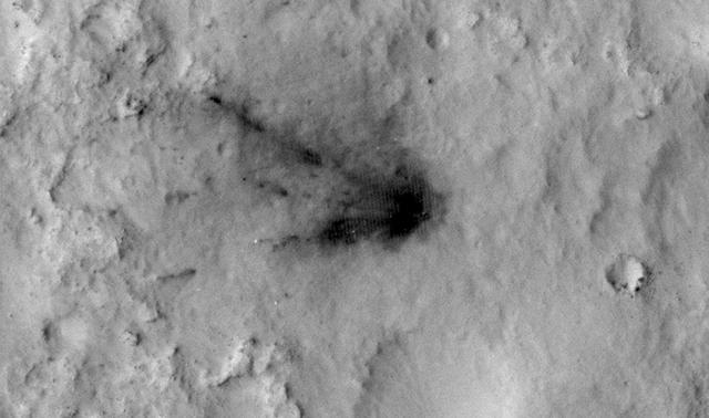This frame from a sequence of images shows a blast zone where the sky crane from NASA Curiosity rover mission hit the ground after setting the rover down in August 2012. The images are from HiRISE on NASA Mars Reconnaissance Orbiter.  http://photojournal.jpl.nasa.gov/catalog/PIA19159