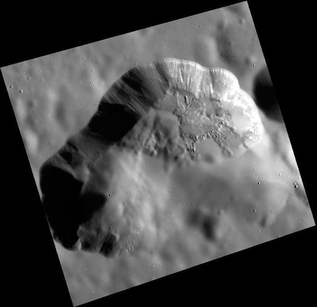 The volcanic vent northeast of Rachmaninoff basin is framed perfectly in this image. The surface in some regions appears smooth, having been blanketed by very fine particles ejected explosively from the vent. Other regions, like those in the right hand side of the depression, exhibit more texture indicating a younger age. The textured walls indicate downslope movement of material, and a bright horizontal layer just beneath the surface can be traced along much of the northeastern wall.   http://photojournal.jpl.nasa.gov/catalog/PIA19223