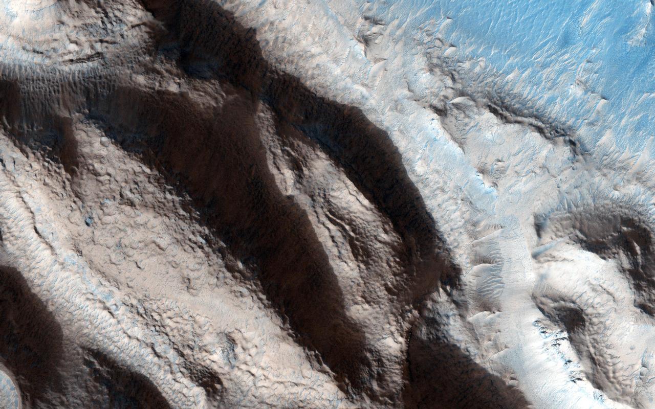 This relatively fresh, shallowly incised valley was once filled with water and/or ice and flowed to the west toward a large, local depression in northern Arabia Terra (36.5 degrees north, 0.3 degrees east). This type of valley is younger and distinct in appearance relative to the ancient valley networks that formed in the Martian highlands. Most fresh, shallow valleys like this one often appear as scattered and isolated or sparsely branched networks of individual valleys in the mid-latitudes and equatorial regions of Mars. The floor of the channel within this broader valley is covered with light-toned transverse aeolian ridges (3 kilometers across). http://photojournal.jpl.nasa.gov/catalog/PIA19301
