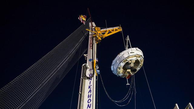 NASA's Low-Density Supersonic Decelerator (LDSD) hangs from a launch tower at U.S. Navy's Pacific Missile Range Facility in Kauai, Hawaii.  The saucer-shaped vehicle will test two devices for landing heavy payloads on Mars: an inflatable donut-shaped device and a supersonic parachute.  The launch tower helps link the vehicle to a balloon; once the balloon floats up, the vehicle is released from the tower and the balloon carries it to high altitudes. The vehicle's rocket takes it to even higher altitudes, to the top of the stratosphere, where the supersonic test begins.  http://photojournal.jpl.nasa.gov/catalog/PIA19342