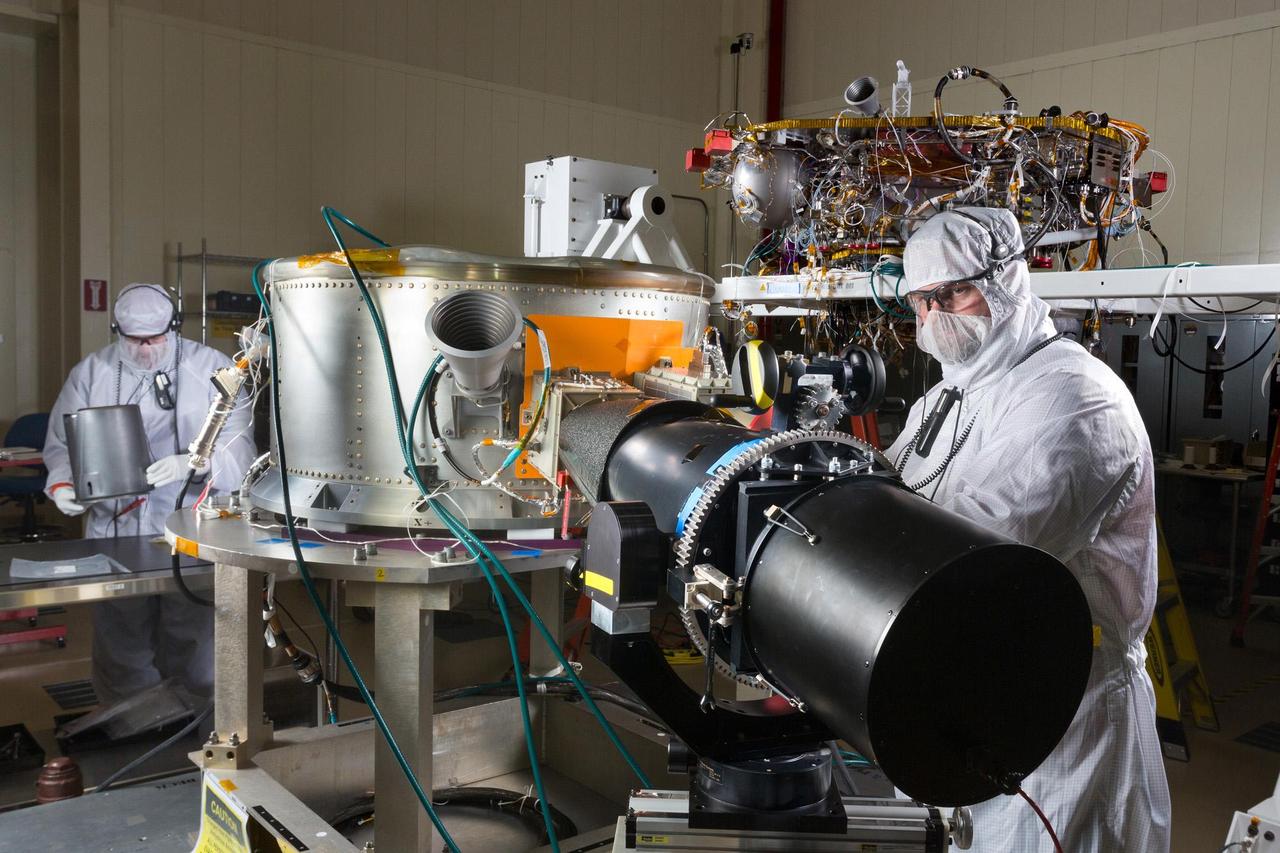 Spacecraft specialists in a clean room at Lockheed Martin Space Systems, Denver, are working on NASA's InSight spacecraft in this January 2015 scene from the mission's assembly and testing phase. At center is the cruise stage, which will serve multiple functions during the flight from Earth to Mars. In the background is the InSight lander. InSight, for Interior Exploration Using Seismic Investigations, Geodesy and Heat Transport, will investigate the deep interior of Mars to gain information about how rocky planets, including Earth, formed and evolved. The mission is scheduled for launch from California in March 2016 and landing on Mars in September 2016. Note: After thorough examination, NASA managers have decided to suspend the planned March 2016 launch of the Interior Exploration using Seismic Investigations Geodesy and Heat Transport (InSight) mission. The decision follows unsuccessful attempts to repair a leak in a section of the prime instrument in the science payload. http://photojournal.jpl.nasa.gov/catalog/PIA19403