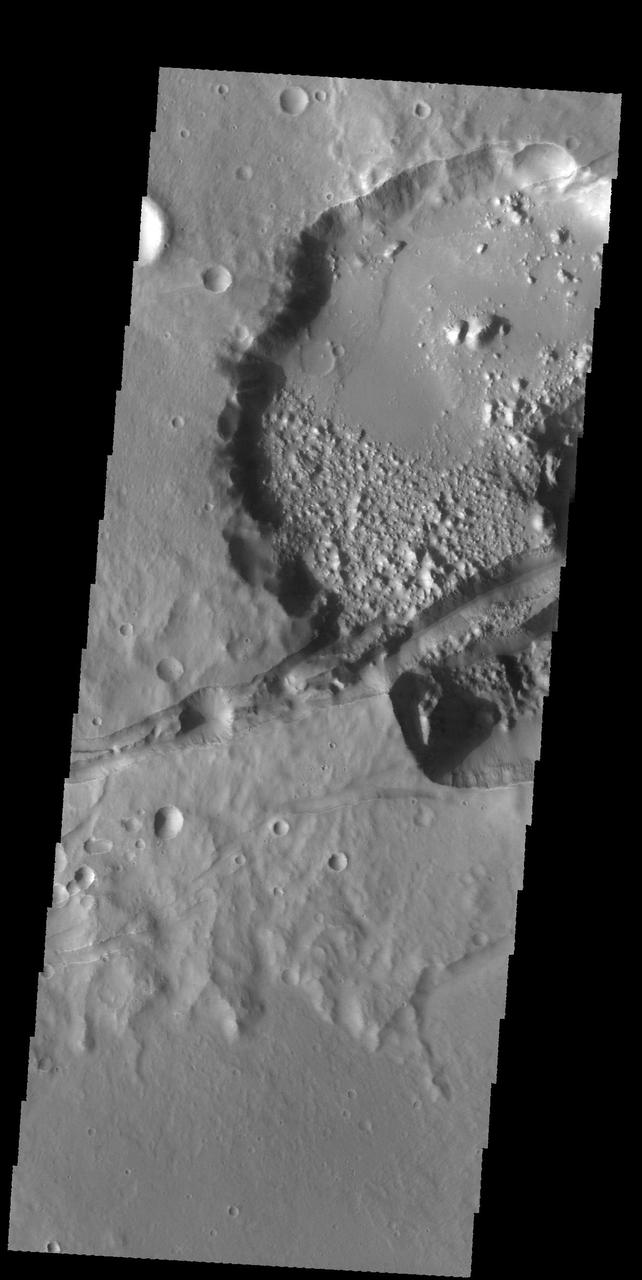 This image captured by NASA 2001 Mars Odyssey spacecraft shows several linear depressions that cross an unnamed crater. The depressions are tectonic fractures that are hundreds of km long. Orbit Number: 58617 Latitude: -29.6672 Longitude: 211.652 Instrument: VIS Captured: 2015-03-02 05:34 http://photojournal.jpl.nasa.gov/catalog/PIA19440