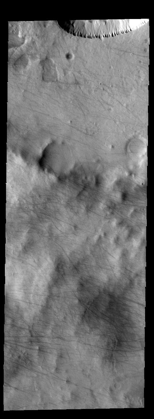 This image captured by NASA 2001 Mars Odyssey spacecraft shows dust devil tracks in Noachis Terra. The dark tracks show where the whirlwind was in contact with the surface and removed dust to expose the darker rocky surface.  Orbit Number: 58911 Latitude: -68.7531 Longitude: 1.20627 Instrument: VIS Captured: 2015-03-26 10:47  http://photojournal.jpl.nasa.gov/catalog/PIA19464