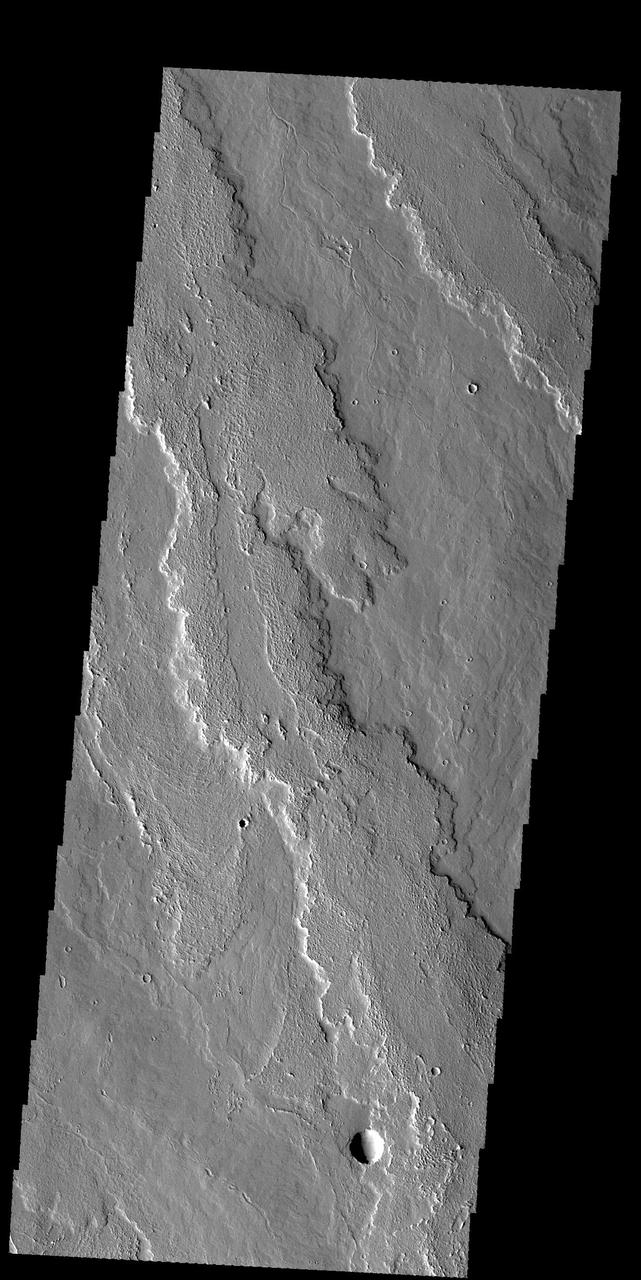 This image captured by NASA 2001 Mars Odyssey spacecraft shows part of the extensive flow field called Daedalia Planum. The lava flows originated at Arsia Mons. Orbit Number: 58928 Latitude: -16.8846 Longitude: 242.147 Instrument: VIS Captured: 2015-03-27 20:06 http://photojournal.jpl.nasa.gov/catalog/PIA19465