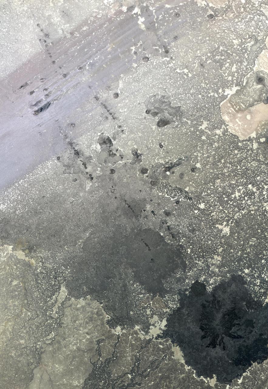 In southern Syria, the Azraq-Wadi as Sirhan Depression is the site of young volcanic activity, producing an extensive basaltic volcanic field. The north-northwest to south-southeast structural and fault control of the crust is evident in the straight alignment of numerous chains of cinder cones. At the top of the image, the northeast trending streaks are windblown sand deposits. The image was acquired May 20, 2009, covers an area of 46.5 x 67 km, and is located at 33.3 degrees north, 37.1 degrees east.   http://photojournal.jpl.nasa.gov/catalog/PIA19479