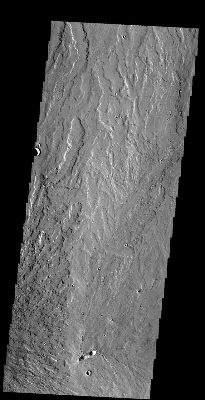 This image captured by NASA 2001 Mars Odyssey spacecraft shows lava flows near the eastern flank of Pavonis Mons.  Orbit Number: 59114 Latitude: 1.42017 Longitude: 250.297 Instrument: VIS Captured: 2015-04-12 05:34  http://photojournal.jpl.nasa.gov/catalog/PIA19480